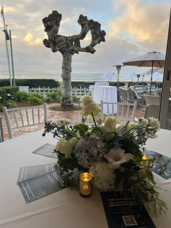 A styled tablescape overlooking the coastline at dusk